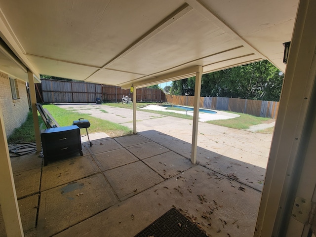 view of patio with a fenced in pool