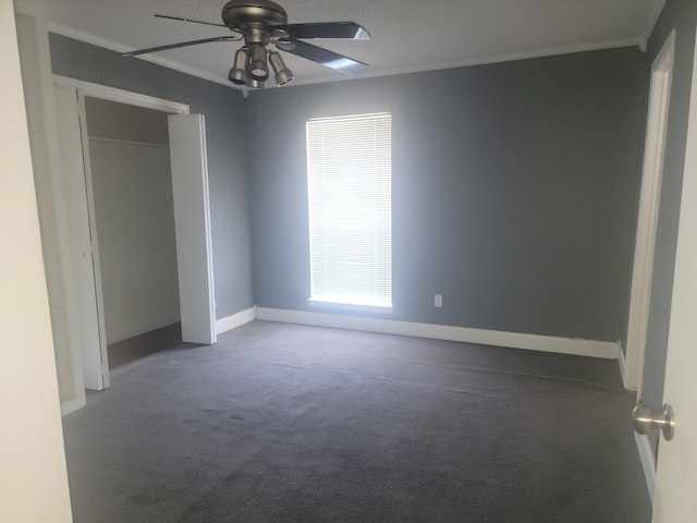 unfurnished bedroom with a closet, ceiling fan, ornamental molding, and carpet floors