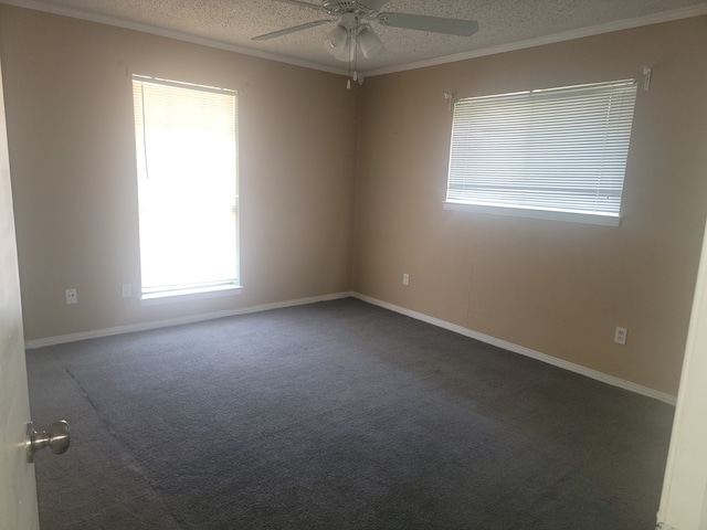 unfurnished room featuring ceiling fan, dark colored carpet, crown molding, and a textured ceiling