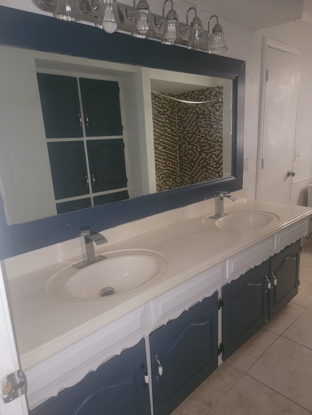 bathroom with vanity, walk in shower, and tile patterned flooring