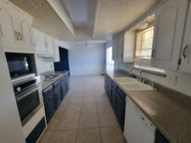 kitchen featuring blue cabinetry, white appliances, sink, ceiling fan, and white cabinets