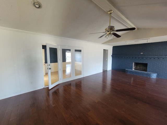 unfurnished living room featuring a fireplace, wood-type flooring, french doors, lofted ceiling with beams, and ceiling fan