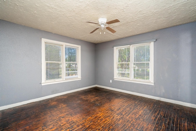 spare room featuring ceiling fan, dark hardwood / wood-style flooring, and a textured ceiling