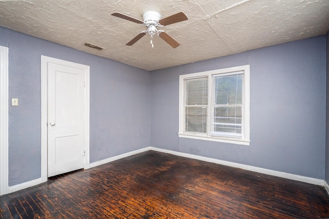 spare room featuring a textured ceiling, ceiling fan, and dark hardwood / wood-style floors