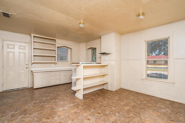 kitchen with built in desk and a textured ceiling