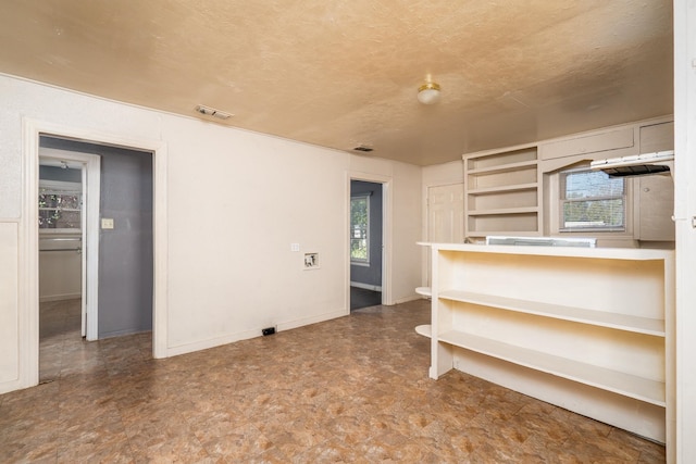 interior space with a wealth of natural light and a textured ceiling