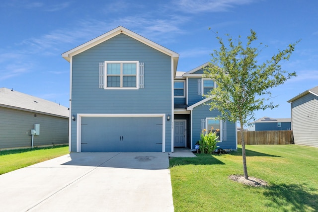 view of property with a garage and a front lawn