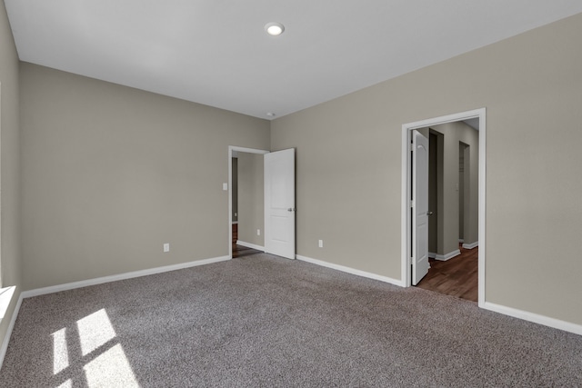 unfurnished bedroom featuring dark carpet