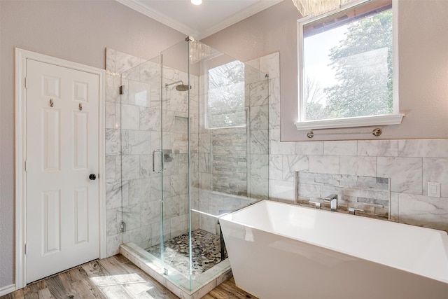 bathroom featuring shower with separate bathtub, hardwood / wood-style flooring, and crown molding