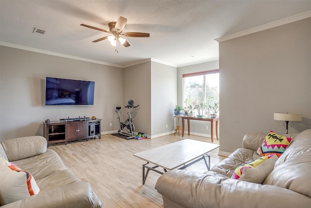 living room with a textured ceiling, ceiling fan, hardwood / wood-style flooring, and crown molding