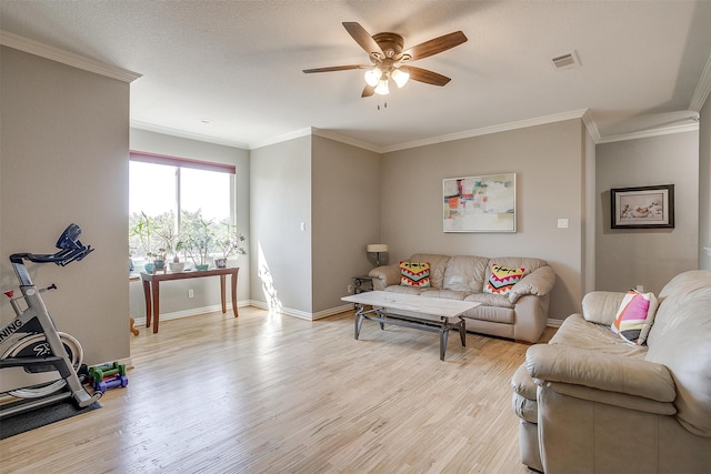 living room with ceiling fan, a textured ceiling, crown molding, and light hardwood / wood-style floors