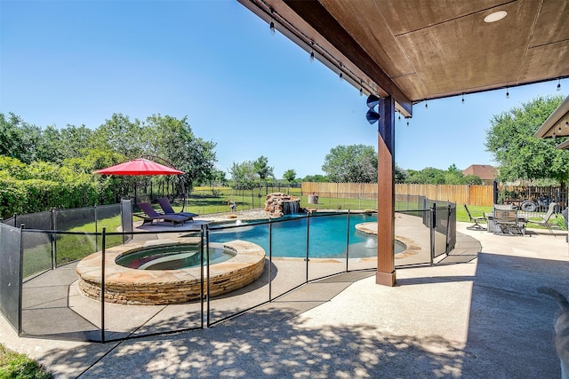 view of swimming pool featuring a patio and an in ground hot tub