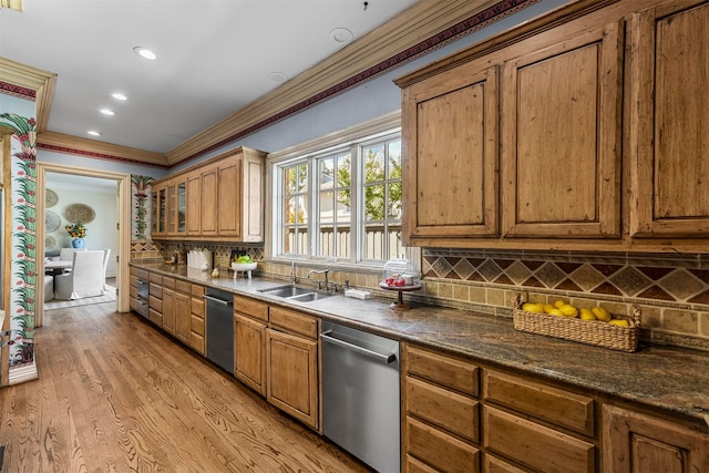 kitchen with light wood-type flooring, tasteful backsplash, crown molding, and stainless steel dishwasher