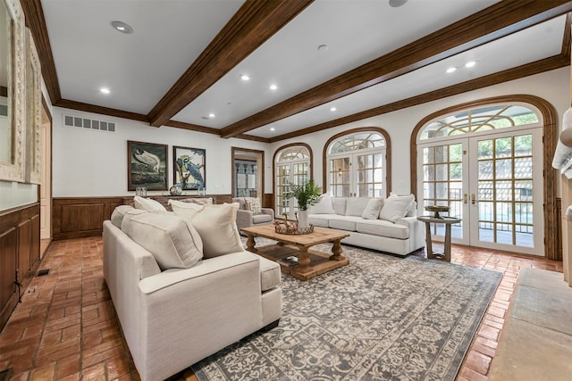 living room with crown molding, beamed ceiling, and french doors