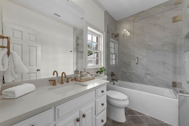 full bathroom featuring vanity, toilet, tile patterned flooring, and enclosed tub / shower combo