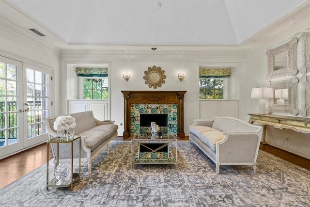 living room featuring a wealth of natural light, french doors, vaulted ceiling, and hardwood / wood-style flooring