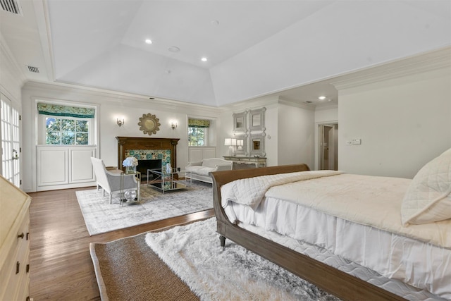 bedroom with crown molding, a premium fireplace, high vaulted ceiling, and dark hardwood / wood-style floors