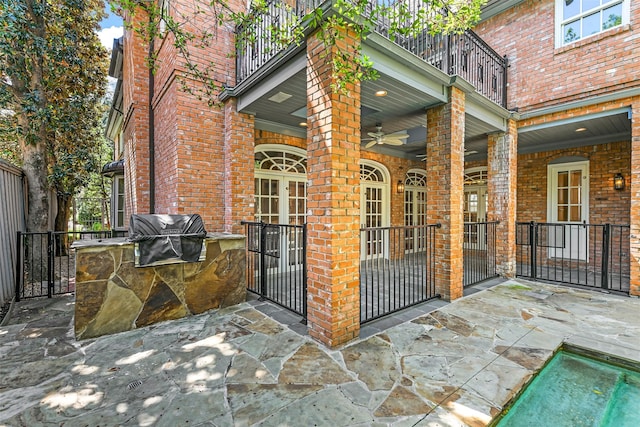 view of patio featuring exterior kitchen, grilling area, and a balcony