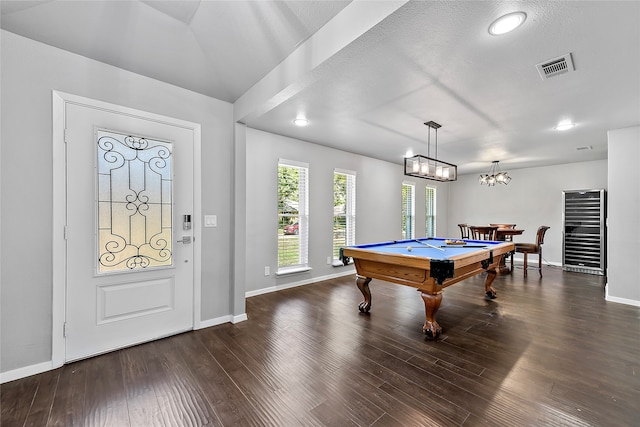 game room featuring a textured ceiling, dark hardwood / wood-style flooring, billiards, and a notable chandelier