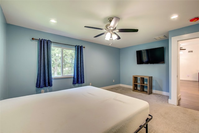 bedroom with light colored carpet and ceiling fan