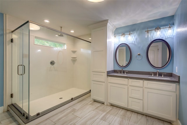 bathroom with a shower with door and vanity