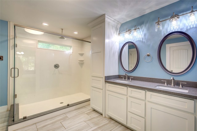 bathroom with vanity and a shower with shower door