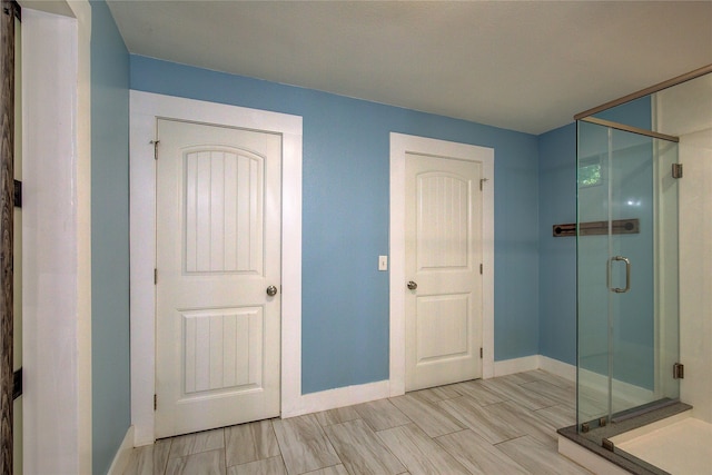 bathroom with a shower with shower door