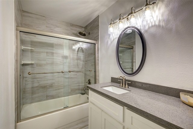 bathroom with bath / shower combo with glass door and vanity