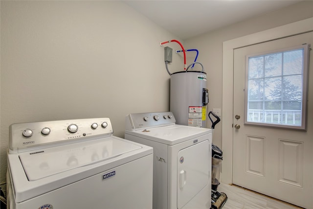 clothes washing area featuring washer and dryer and water heater