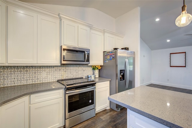 kitchen featuring light stone counters, dark hardwood / wood-style flooring, vaulted ceiling, stainless steel appliances, and decorative light fixtures