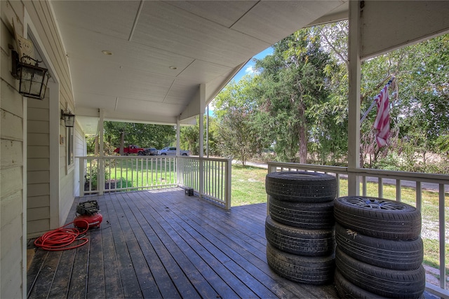 wooden deck featuring a lawn