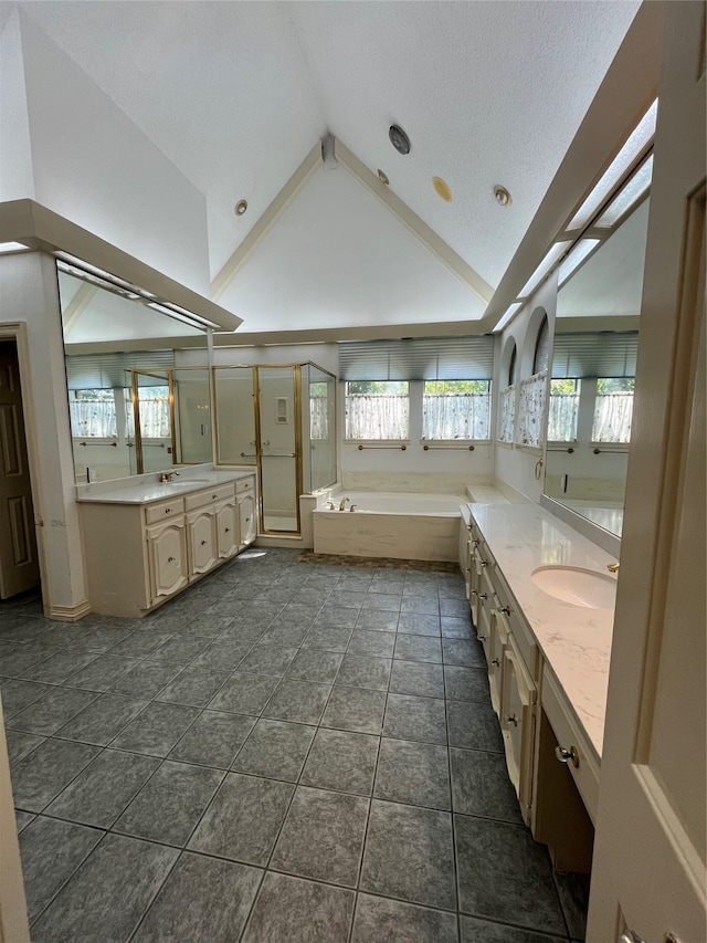 bathroom featuring high vaulted ceiling, vanity, a textured ceiling, shower with separate bathtub, and tile patterned floors