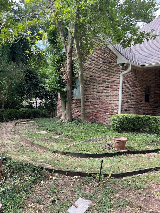 view of side of property with a yard