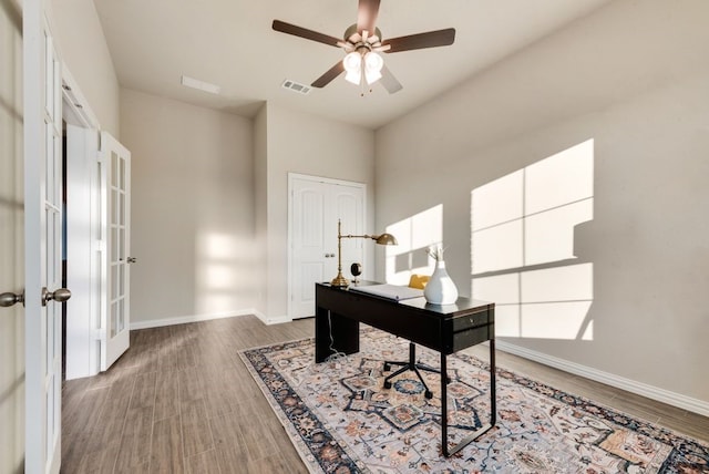 office space featuring ceiling fan, french doors, and dark wood-type flooring