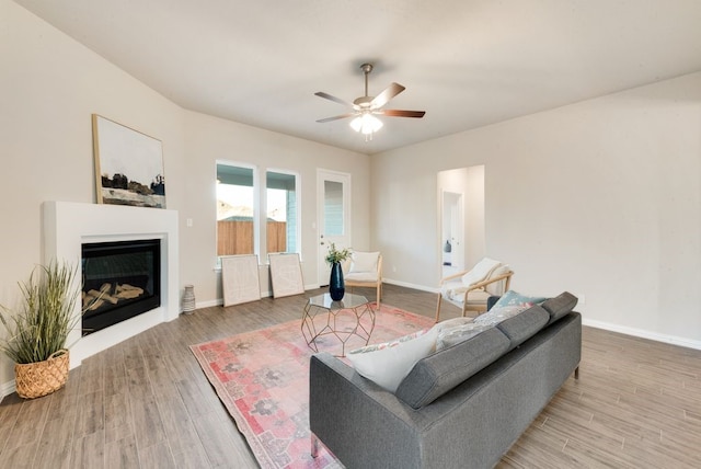 living room with wood-type flooring and ceiling fan