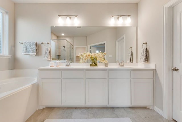 bathroom featuring vanity and plus walk in shower