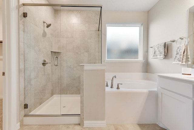 bathroom with vanity and separate shower and tub