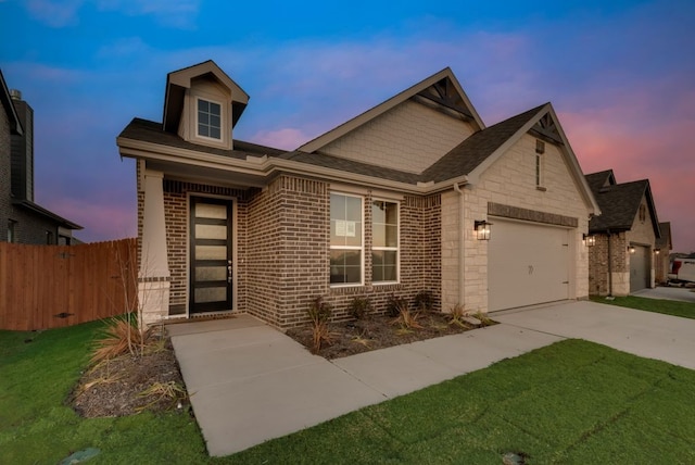 view of front of property featuring a yard and a garage