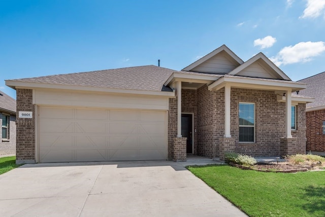 view of front of house featuring a garage and a front yard