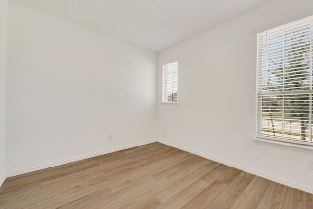 empty room with light hardwood / wood-style floors