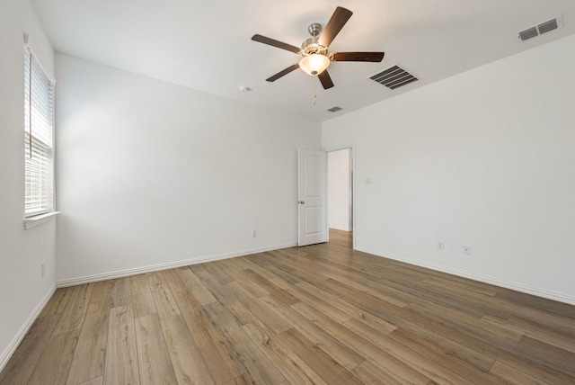 empty room with ceiling fan and light wood-type flooring