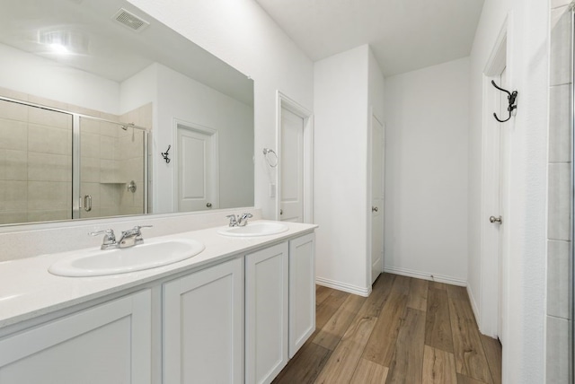 bathroom featuring vanity, hardwood / wood-style floors, and an enclosed shower