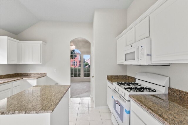 kitchen with white cabinets, white appliances, and dark stone countertops