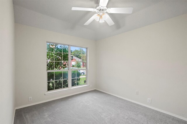 unfurnished room with ceiling fan, vaulted ceiling, and carpet floors