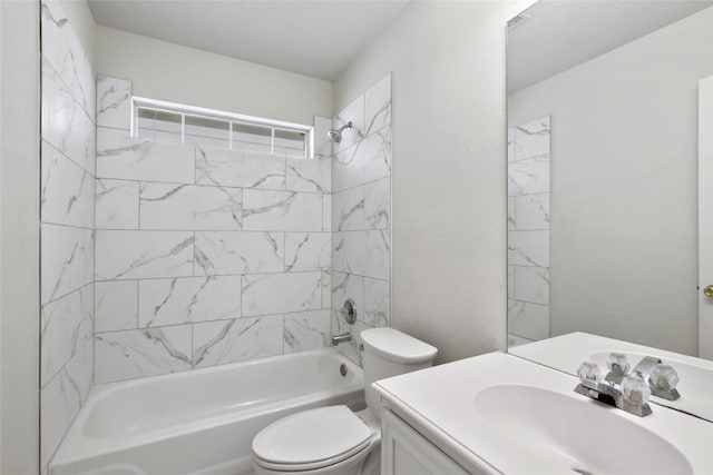 full bathroom featuring tiled shower / bath, toilet, and vanity