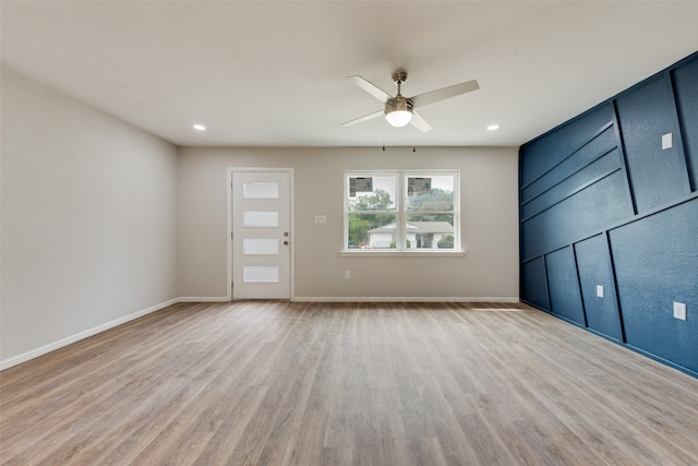 spare room featuring light wood-type flooring and ceiling fan