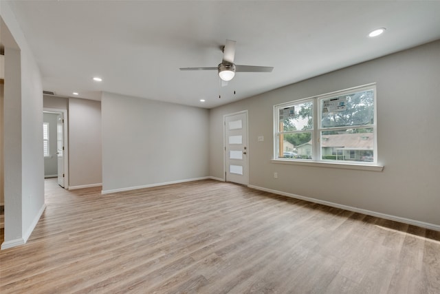 spare room featuring light hardwood / wood-style floors and ceiling fan