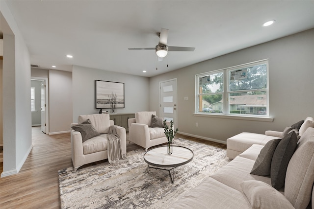 living room featuring light hardwood / wood-style floors and ceiling fan