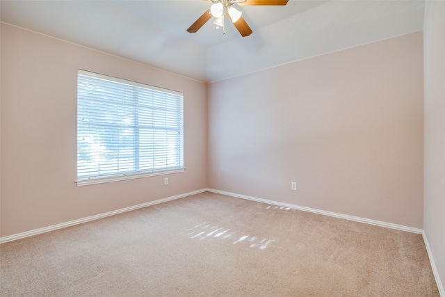 spare room with ceiling fan, light colored carpet, and lofted ceiling