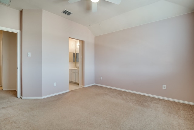 unfurnished bedroom featuring ensuite bathroom, ceiling fan, lofted ceiling, and light carpet